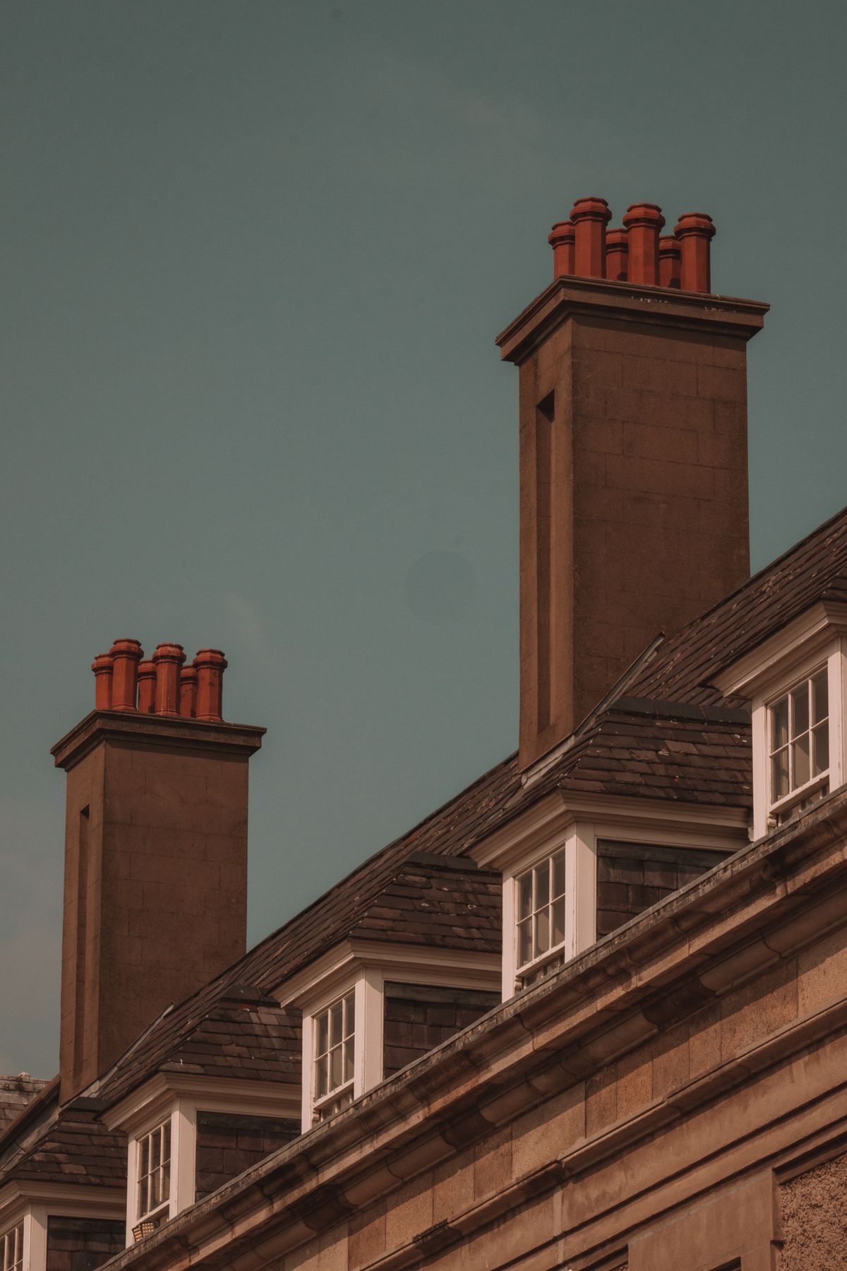 Red brick chimneys on the roof of a house