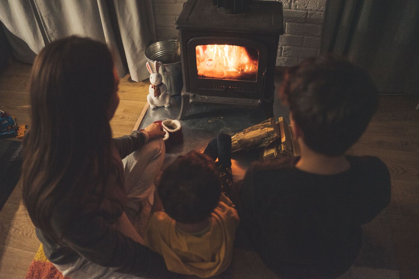 Children relaxing by a warm fireplace