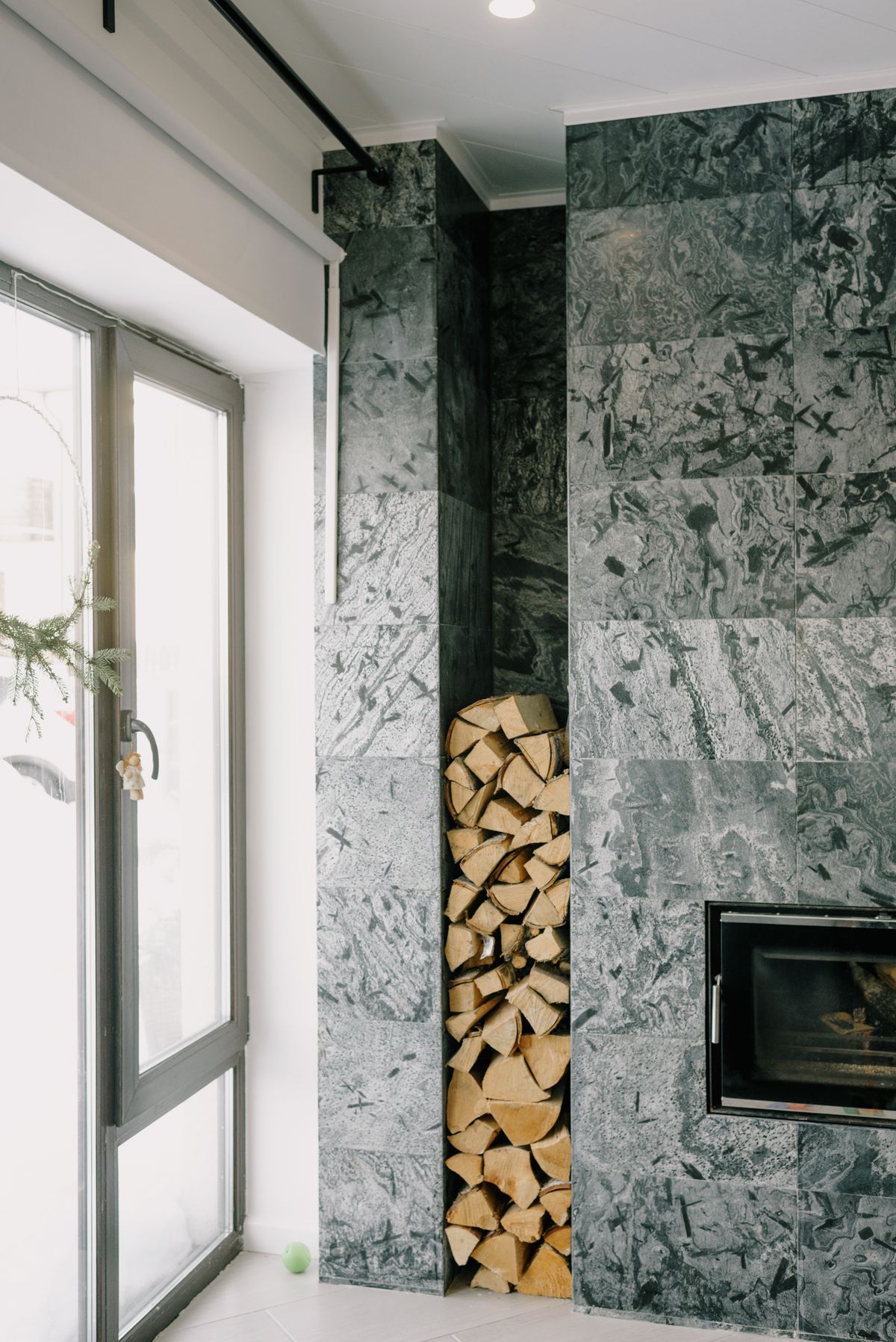 Modern living room with a sleek fireplace and stacked firewood