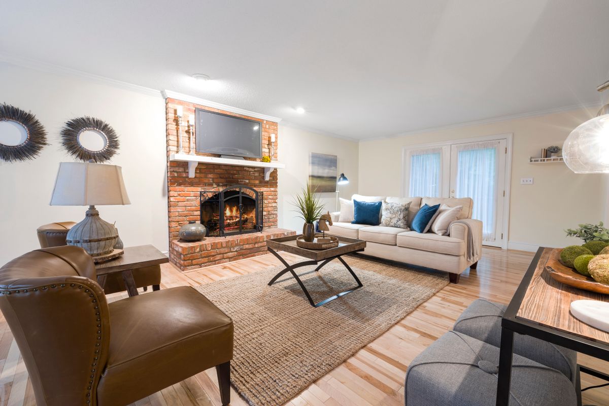 Living room with a brick fireplace and cozy seating