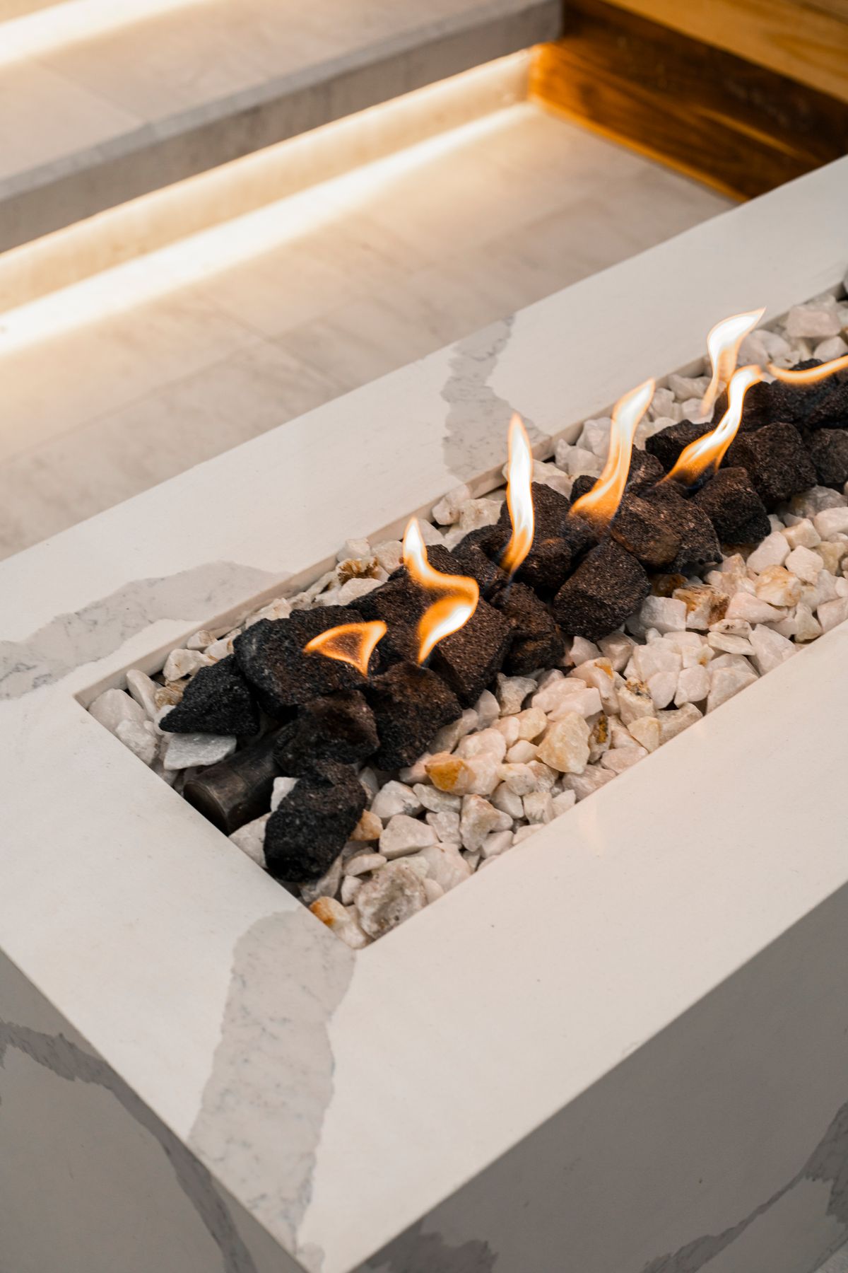 Modern gas fireplace flames over decorative stones