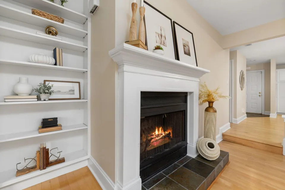 A fireplace and hearth in a bright living room