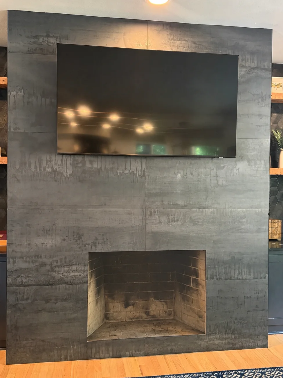 An open, empty firebox in a modern living room before a gas insert was fitted